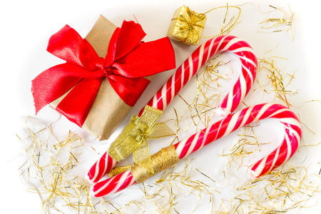 Festive gift boxes with caramel staff on a white background. New Year and Christmas concept. postcard. view from above.の写真素材