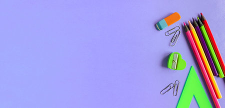 school supplies on a violet background. Space for text.の写真素材