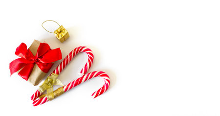 Festive gift boxes with caramel staff on a white background. New Year and Christmas concept. postcard, invitation. view from above. copyspace.の写真素材