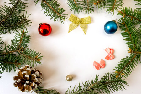Christmas frame of spruce branches and toys on a white background. copyspace.の写真素材