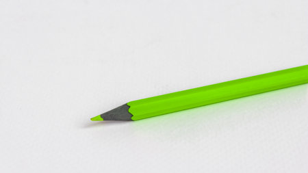 Green pencil on a white background. Minimalism concept.の写真素材