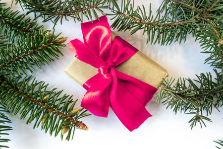 Festive gift box with spruce branches on a white background. The concept of New Year and Christmas. flatlay. postcard.の写真素材