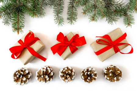 Festive gift boxes with spruce branches and pinecone on a white background. The concept of New Year and Christmas. flatlay. postcard.の写真素材