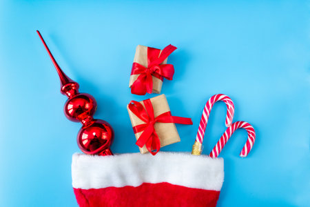 Santa Claus hat with caramel staffs, toy and gift boxes on a white background. postcard. The concept of Christmas and New Year.の写真素材