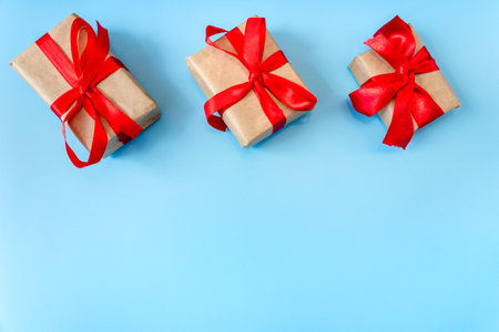 Gift boxes with a red bow on a blue background. Banner. copyspace. flat lay. top view. The concept of any holiday.の写真素材
