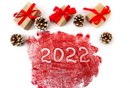 Festive gift boxes with cones and the inscription 2022. White background. The concept of New Year and Christmas.の写真素材
