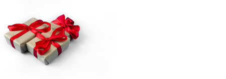 Gift boxes with a red bow on a white background. Banner. copyspace. The concept of any holiday.の写真素材