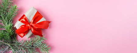 Christmas and New Year's layout on pink background. Postcard made from fir branches and gift box. top view. flat lay. copyspace.の写真素材