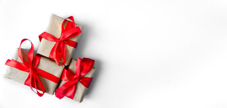 Gift boxes with a red bow on a white background. Banner. copyspace. flat lay. top view. The concept of any holiday.の写真素材