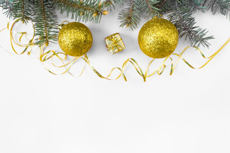 Christmas and New Year's layout on white background. Postcard with a fir branch and toys. top view. flat lay. copyspace.の写真素材