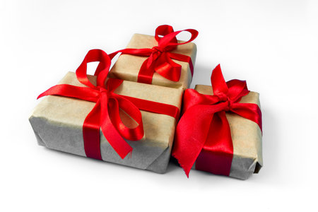 Gift boxes with a red bow on a white background. The concept of any holiday.の写真素材