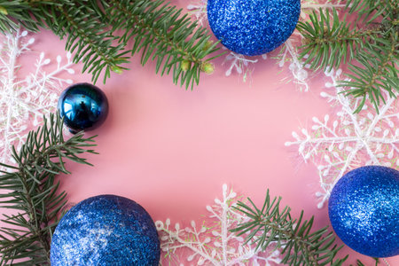 Christmas and New Year's layout on pink background. Frame made of fir branches, snowflakes and toys. top view. flat lay. copyspace.の写真素材