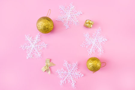 Christmas and New Year's layout on pink background. Frame made of snowflakes and toys. top view. flat lay. copyspace.の写真素材