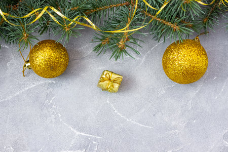 Christmas and New Year's layout on concrete background. Postcard with a fir branch and toys. top view. flat lay. copyspace.の写真素材