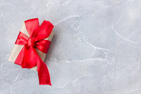 Gift box with a red bow on concrete background. Banner. copyspace. flat lay. top view. The concept of any holiday.の写真素材