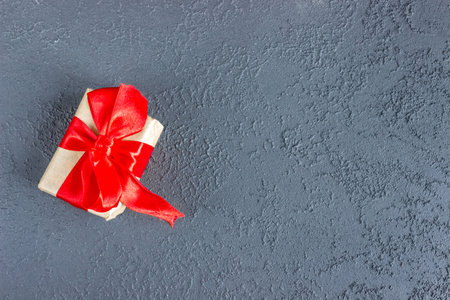Gift box with a red bow on concrete background. Banner. copyspace. flat lay. top view. The concept of any holiday.の写真素材
