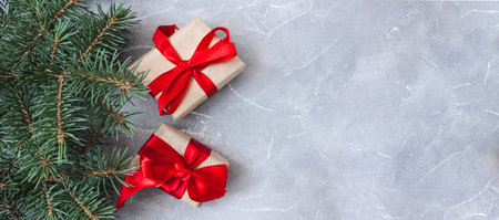 Festive gift boxes with spruce branches on concrete background. The concept of New Year and Christmas. flatlay. copyspace. postcard. Banner.の写真素材