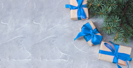 Festive gift boxes with spruce branches on concrete background. The concept of New Year and Christmas. flatlay. copyspace. postcard. Banner.の写真素材
