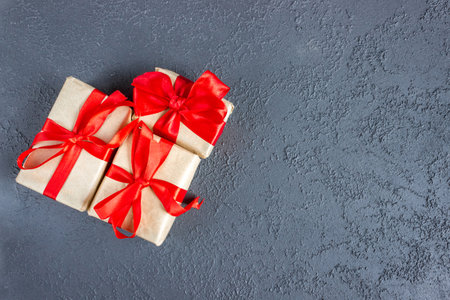 Gift boxes with a red bow on concrete background. Banner. copyspace. flat lay. top view. The concept of any holiday.の写真素材