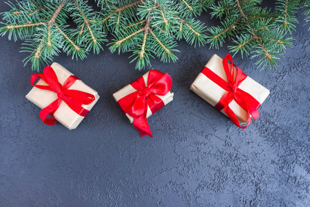 Festive gift boxes with spruce branches on concrete background. The concept of New Year and Christmas. flatlay. copyspace. postcard.の写真素材