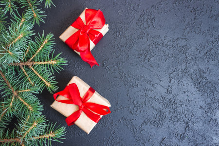 Festive gift boxes with spruce branches on concrete background. The concept of New Year and Christmas. flatlay. copyspace. postcard.の写真素材