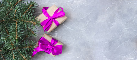 Festive gift boxes with spruce branches on concrete background. The concept of New Year and Christmas. flatlay. copyspace. postcard. Banner.の写真素材