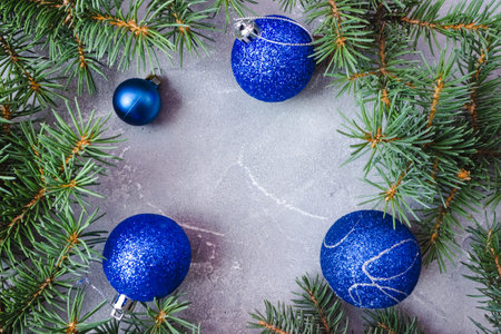 Christmas and New Year's layout on concrete background. Frame made of fir branches and toys. top view. flat lay. copyspace.の写真素材