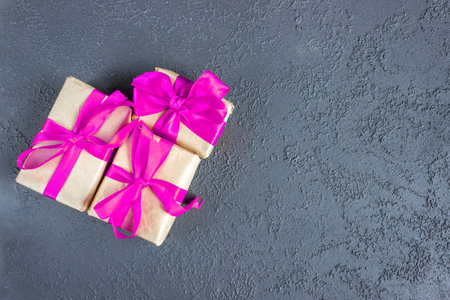 Gift boxes with a pink bow on concrete background. Banner. copyspace. flat lay. top view. The concept of any holiday.の写真素材