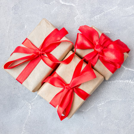 Gift boxes with a red bow on concrete background. Banner. flat lay. top view. The concept of any holiday.の写真素材