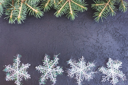 Spruce branches with snowflakes on concrete background. Holiday postcard, invitation. The concept of New Year and Christmas. copyspace.の写真素材