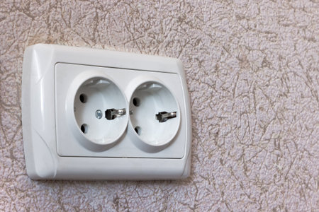 An electrical socket on the wall in the apartment. The concept of energy saving and the safety of using household electrical appliances.の写真素材