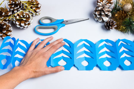 How to make a christmas snowflake from colored paper and glue with your own hands. DIY concept. Step by step giude. Step 14 Glue both halves.の写真素材