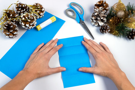 How to make a christmas snowflake from colored paper and glue with your own hands. DIY concept. Step by step giude. Step 8. Do the same on the reverse side.の写真素材