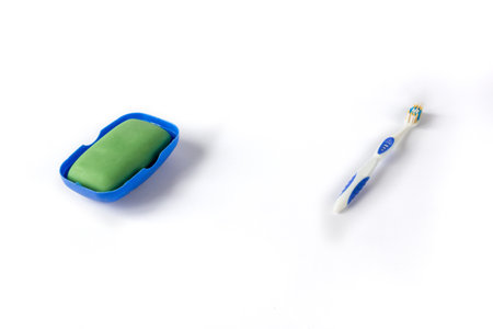 Soap in a soapbox and a toothbrush on a white background. The concept of hygiene.の写真素材