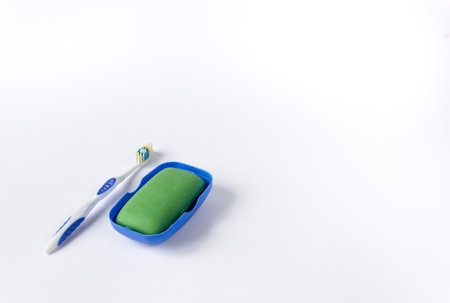 Soap in a soapbox and a toothbrush on a white background. The concept of hygiene.の写真素材