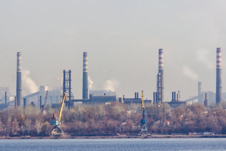 View of the industrial city of Zaporozhye in Ukraine. Smog emissions from chimneys of metallurgical factories. The problem of environmental pollution and global warming.の写真素材