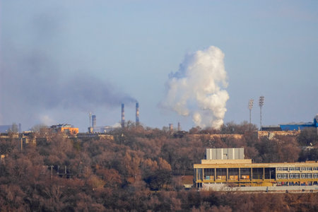 View of the industrial city of Zaporozhye in Ukraine. Smog emissions from chimneys of metallurgical factories. The problem of environmental pollution and global warming.の写真素材