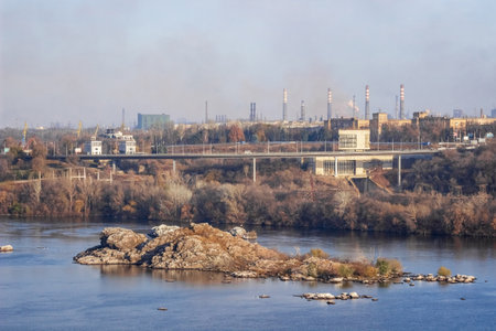Emission of smoke from pipes of a metallurgical plant. The problem of air pollution and global warming. environmental protection concept. Zaporozhye, Ukraine. View of the Dnieper river.の写真素材