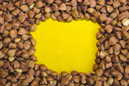 Buckwheat grains on a yellow background. Space for text.の写真素材