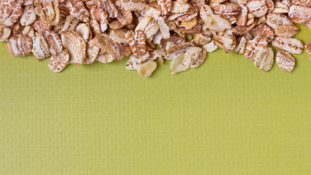 Green background with oat flakes. view from above. Space for text.