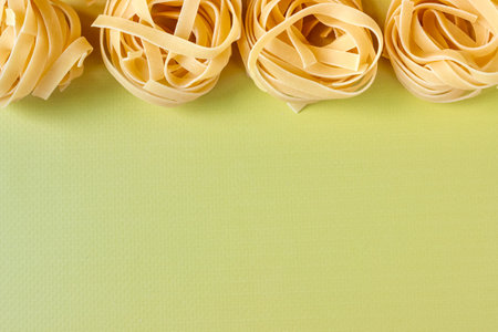 Green background with raw spaghetti. view from above. Space for text.の写真素材
