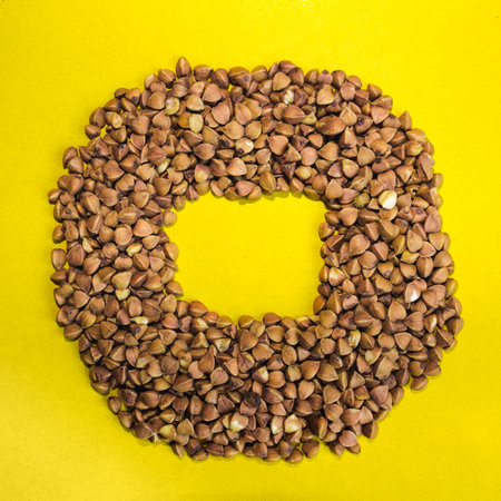 Buckwheat grains on a yellow background. Space for text.の写真素材