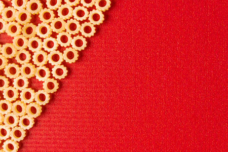 Figure pasta on a red background. Space for text.の写真素材