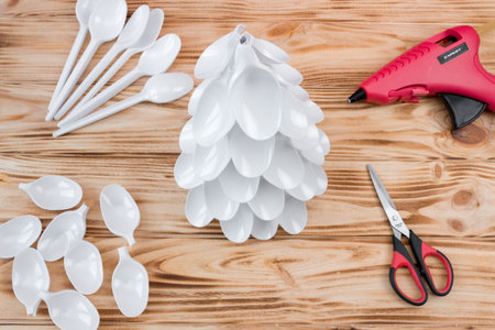 Christmas tree made of disposable spoons. step by step instruction. Handmade, DIY. Plastic recycling concept.の写真素材