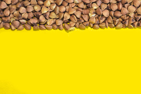 Buckwheat grains on a yellow background. Space for text.の写真素材