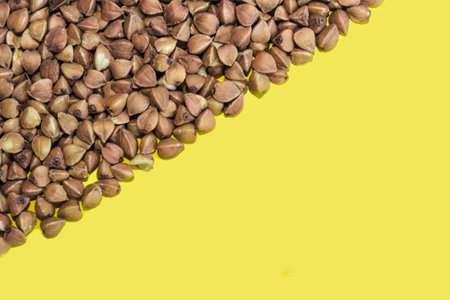 Buckwheat grains on a yellow background. Space for text.の写真素材