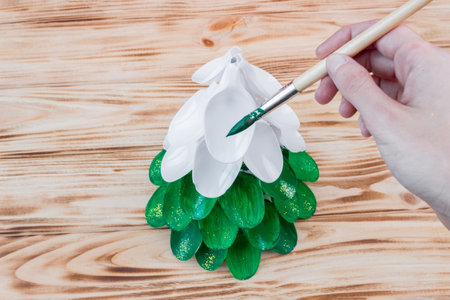 Christmas tree made of disposable spoons. step by step instruction. Handmade, DIY. Plastic recycling concept.の写真素材