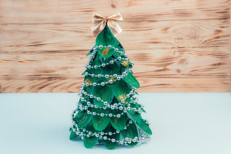 Christmas tree made of disposable spoons. step by step instructions. Handmade, DIY. Plastic recycling concept. The final result.の写真素材