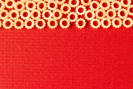 Figure pasta on a red background. Space for text.の写真素材