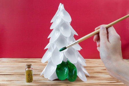 Christmas tree made of disposable spoons. step by step instruction. Handmade, DIY. Plastic recycling concept.の写真素材